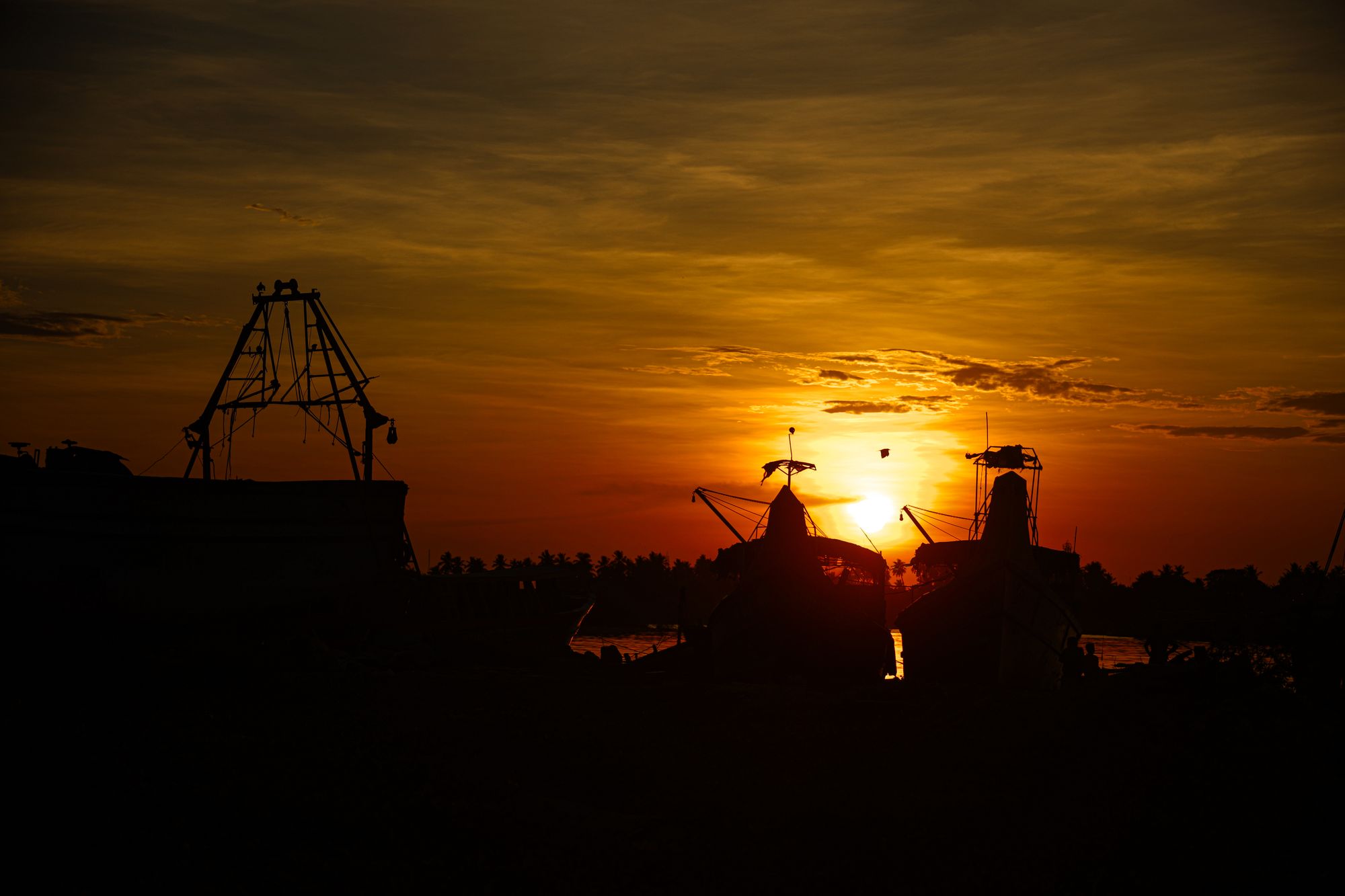 Sunset over the water on Block Island, with boats silhouetted against a pink sky